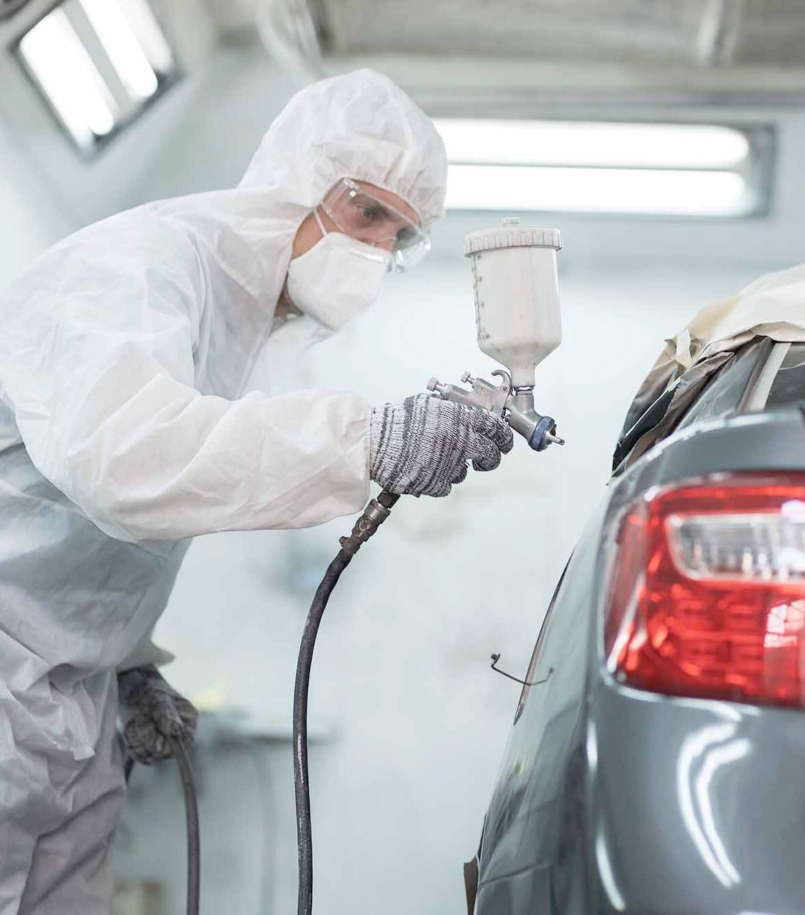 auto paint repair expert spraying car